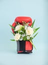 Spring flower bouquet in red boxing gloves on minimal blue background for strong Mother or woman`s day concept