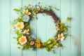 Spring flower wreath on an old rustic blue wood background