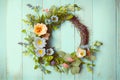 Spring flower wreath on an old rustic blue wood background