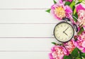 Spring flowers and Alarm Clock. Change the time. Royalty Free Stock Photo