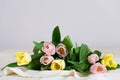 Spring flowers. Bouquet of pink yellow tulips on beige fabric background. Mother`s Day, Valentines Day and Happy birthday