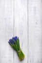 Spring flowers bouquet on wooden table. Top view, copy space.