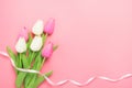 Spring flowers bunch of pink and white tulips on the pink background with free space for text.