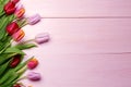 Spring flowers composition on the wooden background.Top view colorful tulips  on a wooden surface. Royalty Free Stock Photo