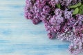 Spring flowers. Frame of twigs of blooming lilac on a blue wooden table. top view. place for text Royalty Free Stock Photo