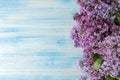 Spring flowers. Frame of twigs of blooming lilac on a blue wooden table. top view. place for text Royalty Free Stock Photo