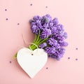 Spring flowers and a heart shape tag mockup on pink for Mother`s day. Royalty Free Stock Photo