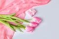 Pink tulips bouquet with gift box on a table Royalty Free Stock Photo