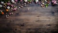 spring flowers and scattered petals on rustic wooden texture table top view with copy space