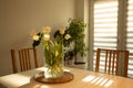 Spring flowers - white tulips in glass vase on wooden table Royalty Free Stock Photo