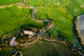 Spring flying at the landscape on sunset over blooming fields