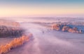 Spring foggy aerial landscape. Aerial drone view of spring field with fog.