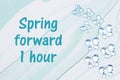 Spring forward 1 hour message with blue glass butterflies on blue watercolor paper Royalty Free Stock Photo