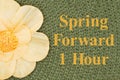 Spring Forward message with a flower on olive green fabric material Royalty Free Stock Photo