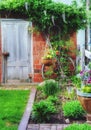 Spring garden area with old building and wisteria vine. Royalty Free Stock Photo