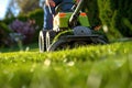 Spring Garden Maintenance: Worker Operating Lawn Mower Royalty Free Stock Photo