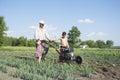 Spring in the garden man plowing land motor-block small son and Royalty Free Stock Photo