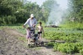 Spring in the garden man plowing land motor-block small son and Royalty Free Stock Photo