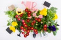 Spring Garden Works Concept. Gardening tools, flowers in pots and watering can on white table. flat lay Royalty Free Stock Photo