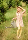 Spring gardening checklist. Watering plants in garden. Watering tools. Girl child hold watering can. Improve irrigation Royalty Free Stock Photo
