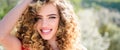 Spring girl with curly hair smiling. Beauty young woman enjoying nature in spring garden. Banner spring design Royalty Free Stock Photo