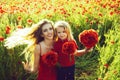 Spring girl and little boy or child in field of poppy. Royalty Free Stock Photo