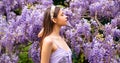 Spring girl portrait. Woman near blossom spring park. Woman on spring blooming tree. Beautiful young woman in springs Royalty Free Stock Photo