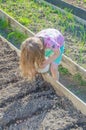 Planting bulbs as a girl on a Sunny day