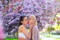 Spring girls. Lesbian couple kissing. Beautiful spring sexy girl with sakura flowers. Sensual kiss. Girlfriends love. Royalty Free Stock Photo