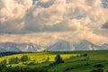 Spring green mountain landscape with meadows and rocky peaks. Landscape with a chapel and snow-covered Tatra Mountains Royalty Free Stock Photo