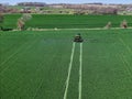 John Deere R4038 self propelled sprayer applying herbicide to winter wheat