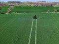 John Deere R4038 self propelled sprayer applying herbicide to winter wheat Royalty Free Stock Photo