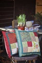 Spring handmade patchwork cushions with narcissus bulbs on background