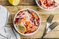 Spring healthy vegan salad with raw beet, carrot and cabbage in white bowls. Alkaline Diet concept. Top view. Flat lay