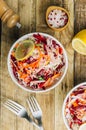 Spring healthy vegan salad with raw beet, carrot and cabbage in white bowls. Alkaline Diet concept. Top view. Flat lay