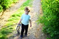 Spring holiday. Sunny weather. Small child with toy in shopping bag. summer. Little boy child in green forest. Happy kid Royalty Free Stock Photo