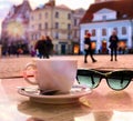 Spring holiday Street cafe in romantic spring  Tallinn old town ,cup of coffee on table top ,spring flowers bouquet Royalty Free Stock Photo