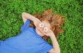 Spring kid. Happy child enjoying on grass field and dreaming. Funny little boy with daisy in eyes. Royalty Free Stock Photo