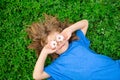 Spring kid. Happy child enjoying on grass field and dreaming. Funny little boy with daisy in eyes. Royalty Free Stock Photo