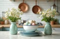 Spring kitchen setup with daisy bouquets, pastel Easter eggs in a bowl, and stacked plates. Decorate your home with fresh flowers Royalty Free Stock Photo
