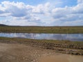 Sky, field and puddle. Royalty Free Stock Photo