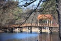 spring on the lake. Clear sky with light clouds and trees are reflected in the water