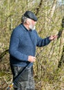 Spring landscape with an angler, an angler inspecting fishing rods, lake shore, spring Royalty Free Stock Photo