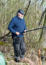Spring landscape with an angler, an angler inspecting fishing rods, lake shore, spring Royalty Free Stock Photo
