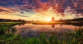 Spring landscape of bright sunrise over river with colorful cloudy sky on horizon. Scenery spring nature