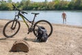 Spring landscape with a cyclist resting after a trip along the Kuban River near the city of Krasnodar.