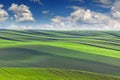 Spring Landscape of fields in beautiful striped hills valley