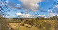 Spring landscape of grassy mound and cloudy sky Royalty Free Stock Photo