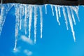 Spring landscape with ice icicles hanging from roof of house Royalty Free Stock Photo