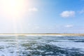 Spring landscape with a lake covered by melting snow, clear sky. Landscape with melting ice on the surface of the lake Royalty Free Stock Photo